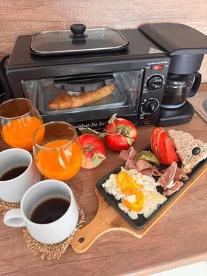 a table with a plate of food and a toaster at Honey House in Bansko