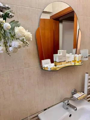 a bathroom with a mirror and a sink at Honey House in Bansko