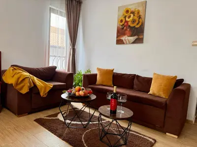 a living room with a couch and a table with fruit on it at Honey House in Bansko