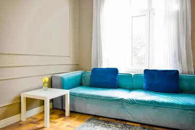 a blue couch in a living room with a table at 2bdr Luxury On Prime Location in Sofia