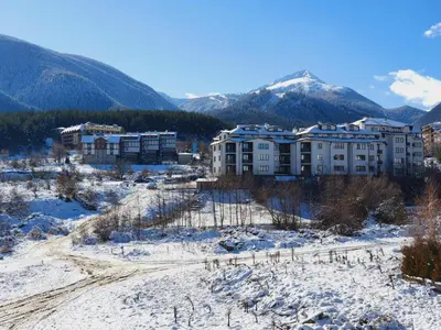 a resort in the snow with mountains in the background at BANSKO WINSLOW INFINITY - Studio in Bansko