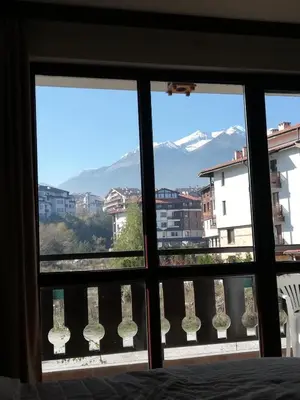a view from a bedroom window of a mountain at BANSKO WINSLOW INFINITY - Studio in Bansko