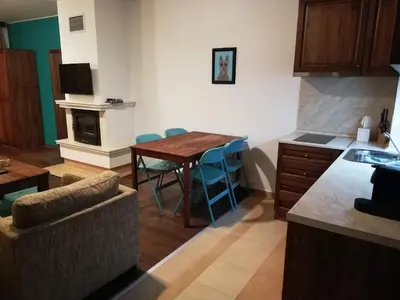 a kitchen with a table and chairs in a room at BANSKO WINSLOW INFINITY - Studio in Bansko