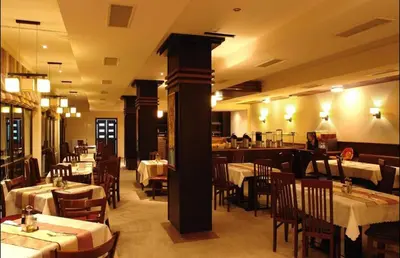 a restaurant with tables and chairs in a room at BANSKO WINSLOW INFINITY - Studio in Bansko