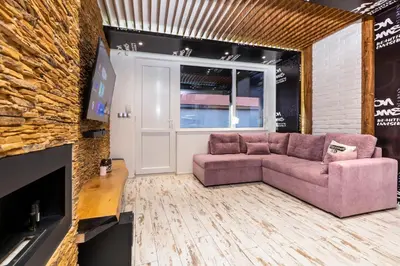 a living room with a couch and a fireplace at Modern 1BD Flat with a Parking near the city centre by Flat Mаnager in Plovdiv