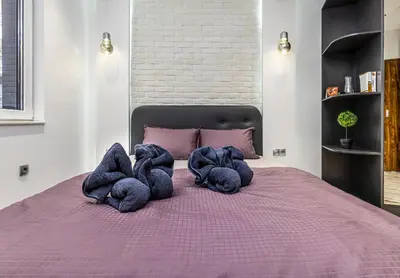 a bedroom with a purple bed with two sloth cushions at Modern 1BD Flat with a Parking near the city centre by Flat Mаnager in Plovdiv