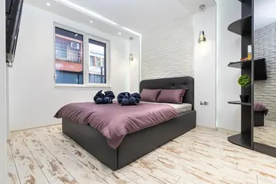 a bedroom with a bed with purple sheets and a window at Modern 1BD Flat with a Parking near the city centre by Flat Mаnager in Plovdiv
