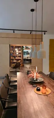 a dining room with a large wooden table and chairs at GORA - Вила Villa for 22 Guests, Пампорово, Rhodope Mountains in Progled