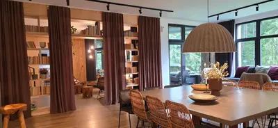a dining room and living room with a table and chairs at GORA - Вила Villa for 22 Guests, Пампорово, Rhodope Mountains in Progled