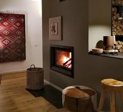 a living room with a fireplace on the wall at GORA - Вила Villa for 22 Guests, Пампорово, Rhodope Mountains in Progled