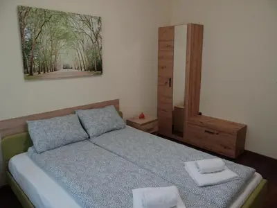 a bedroom with a bed and a painting on the wall at Villa Camino in Sapareva Banya