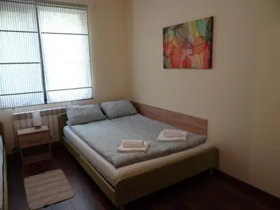 a small bedroom with a bed with two towels on it at Villa Camino in Sapareva Banya