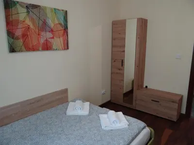 a bedroom with two beds and a mirror with towels at Villa Camino in Sapareva Banya