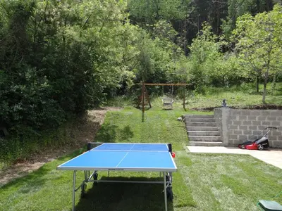 a blue ping pong table sitting in the grass at Villa Camino in Sapareva Banya