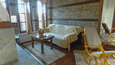 a living room with a couch and a table at Leshtenski Rai Guest House in Leshten