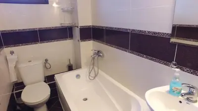 a bathroom with a toilet and a tub and a sink at Leshtenski Rai Guest House in Leshten