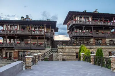 two large wooden buildings with balconies on them at Leshtenski Rai Guest House in Leshten