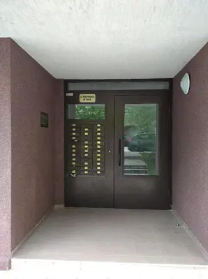 a entrance to a building with a revolving door at Karastoyanovi's Apartment in Sofia