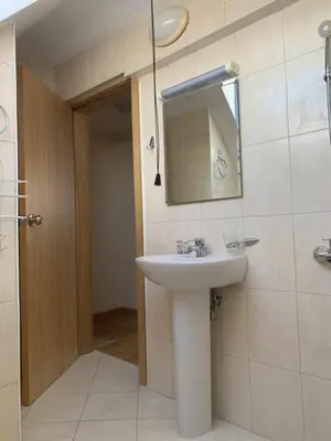 a bathroom with a sink and a mirror at Bansko Ski to Door Apartment in Bansko