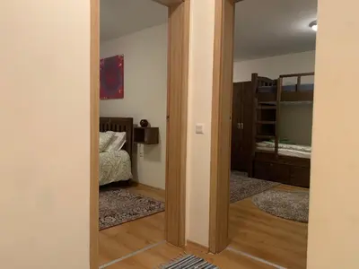 a door leading into a bedroom with a bunk bed at Bansko Ski to Door Apartment in Bansko