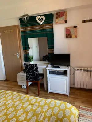 a room with a desk with a computer and a mirror at Bansko ski apartment Mountain View Resort in Bansko