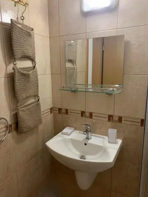 a bathroom with a sink and a mirror at Bansko ski apartment Mountain View Resort in Bansko