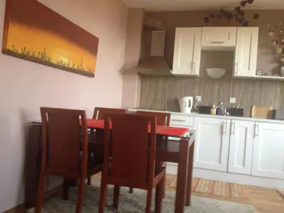 a kitchen with a table and chairs in a room at Bansko ski apartment Mountain View Resort in Bansko