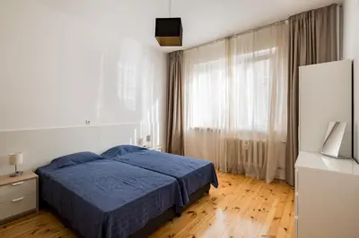 a bedroom with a blue bed and a window at Spacious 3 Bedroom Home in Sofia's Top Center in Sofia