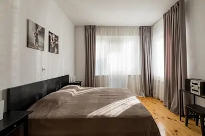 a bedroom with a large bed and a window at Spacious 3 Bedroom Home in Sofia's Top Center in Sofia