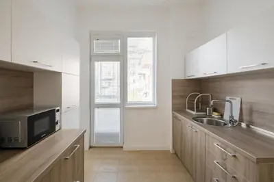 a kitchen with a sink and a microwave at Spacious 3 Bedroom Home in Sofia's Top Center in Sofia