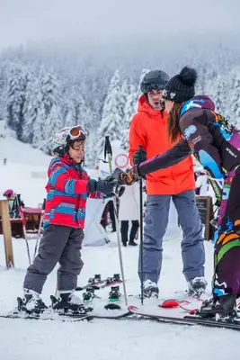 a group of people on skis in the snow at Тайната квартира - The Secret apartment in Pamporovo