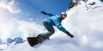 a man riding a snowboard down a snow covered slope at Тайната квартира - The Secret apartment in Pamporovo