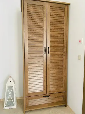 a wooden cabinet in the corner of a room at Studio Chalet 13, St John Park Bansko in Bansko