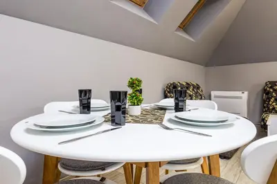 a white dining room with a white table and chairs at Beautiful 1BD Apartment with a Parking Spot by Flat Mаnager in Plovdiv