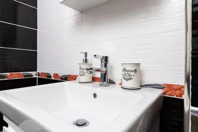 a bathroom sink with two cups on top of it at Beautiful 1BD Apartment with a Parking Spot by Flat Mаnager in Plovdiv