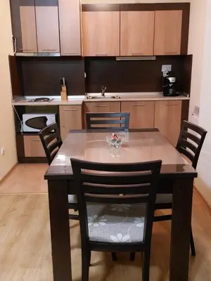 a kitchen with a table and chairs in a room at Pamporovo Apartment The Castle in Pamporovo