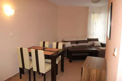 a living room with a table and a couch at Winter Аpartments Gerovi in Pamporovo