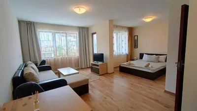 a living room with a couch and a bed at Prime Apartments in Bansko
