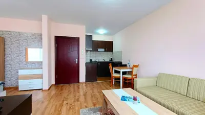 a living room with a couch and a table at Prime Apartments in Bansko