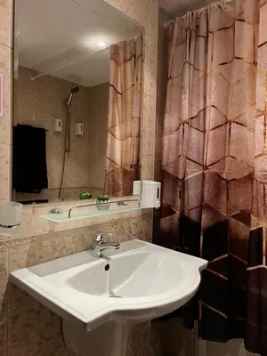 a bathroom with a sink and a mirror at Luxury studio in Bansko