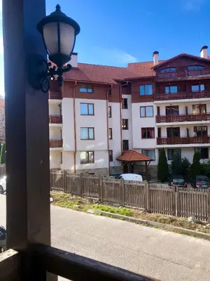 a view of a building with a fence and a street at Luxury studio in Bansko