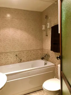 a bathroom with a tub and a toilet and a sink at Luxury studio in Bansko