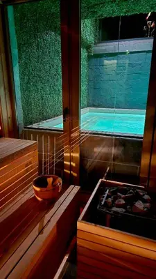 a bathroom with a tub and a swimming pool at BOUTIQUE Hotel ENTRY E in Bansko