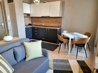 a living room with a blue couch and a table at BOUTIQUE Hotel ENTRY E in Bansko