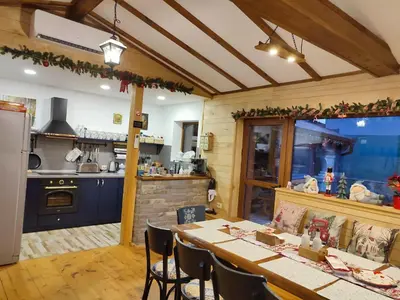 a kitchen with a table and chairs in a kitchen at Villa Boro in Beli Iskar