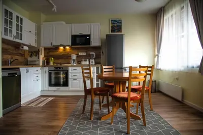 a kitchen with a table and chairs in it at Bansko Ski Apartment in Bansko