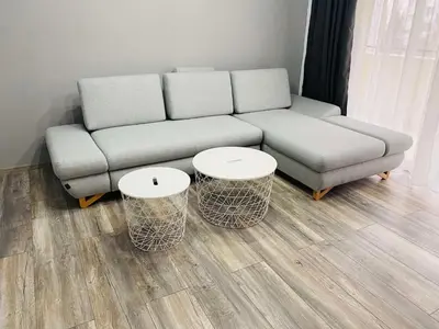 a living room with a couch and two tables at Aparthouse Heaven in Sandanski