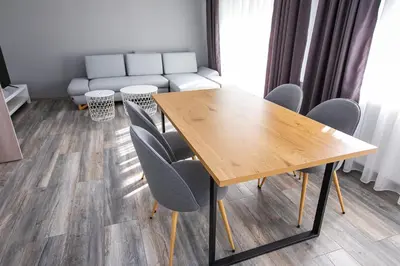 a dining room with a wooden table and chairs at Aparthouse Heaven in Sandanski