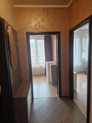 a bathroom with a mirror and a door to a room at Апартамент Лукс в Спа Хотел Свети Спас in Velingrad