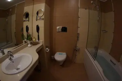 a bathroom with a sink and a toilet and a shower at Апартамент Лукс в Спа Хотел Свети Спас in Velingrad